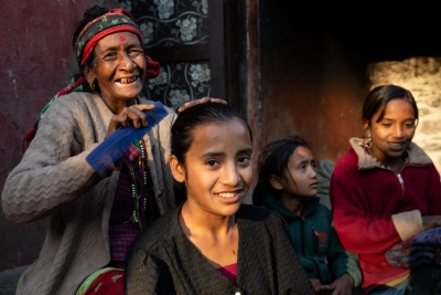 Grandma Keshari helps to fix Sharmila’s hair before she goes to school.