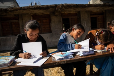 Sharmila concentrates on her schoolwork with her classmates.