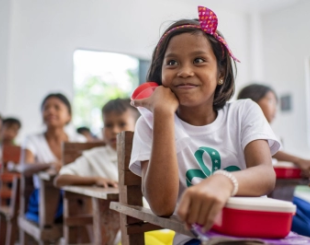 A girl with her meal at school. 