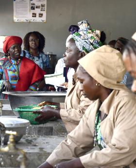 Benin's Vice President, Mariam Talata speaks to women at the rice processing centre in Bantè.